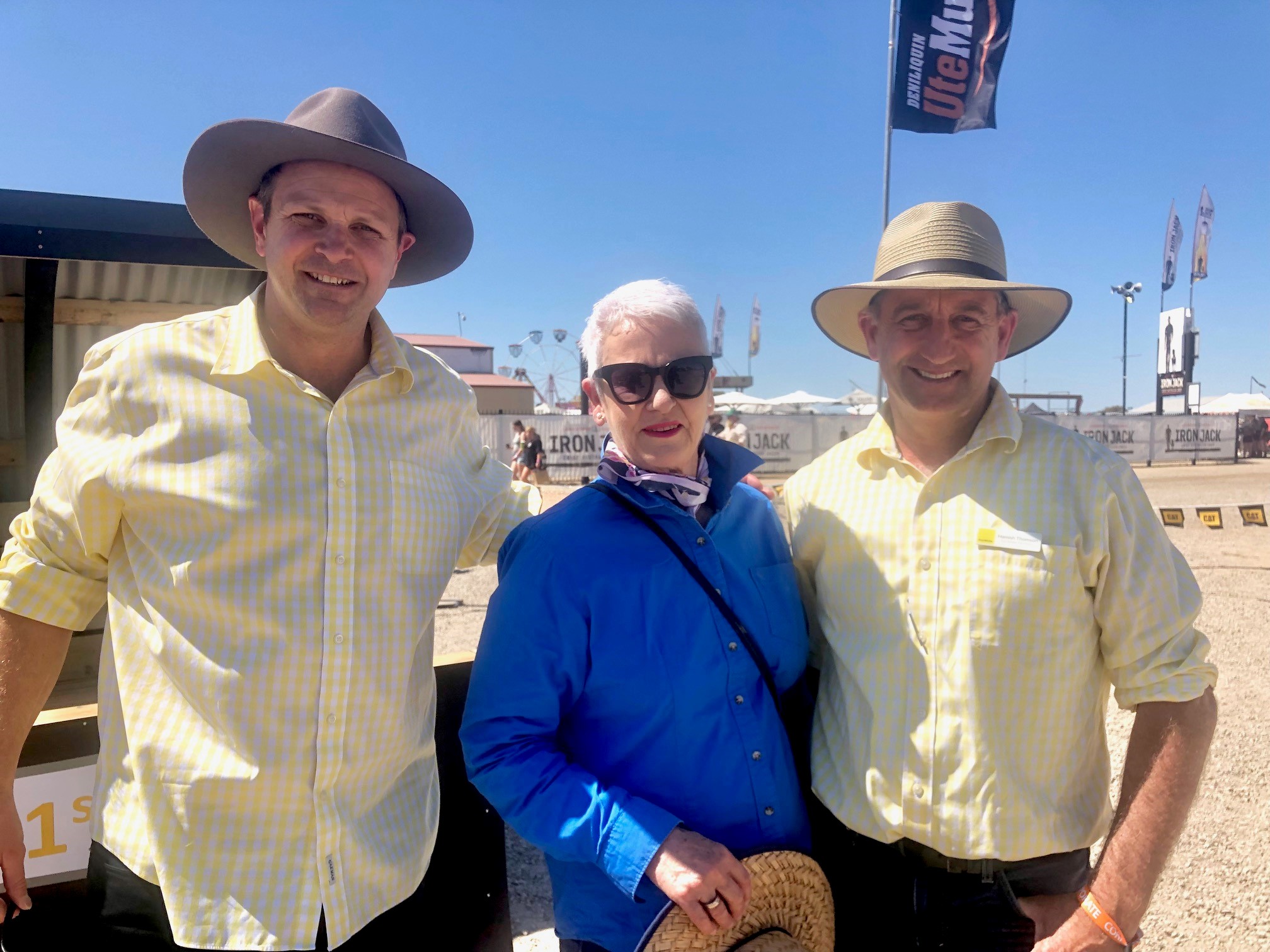 Ray White Deniliquin auctioneers Sam Hall and Hamish Thomson with Country Education Foundation Edward River Region committee member Marg Bull at the 2023 Deni Ute Muster sandpit auction fundraiser for CEF Edward River.