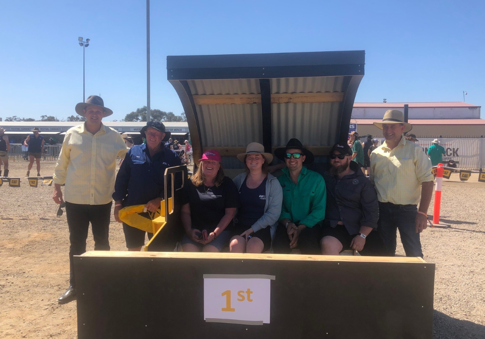 Country Education Foundation of Edward River Region volunteers with Ray White Deniliquin auctioneers and the winning sand pit at the sand pit auction fundraiser for CEF Edward River at the 2023 Deni Ute Muster.